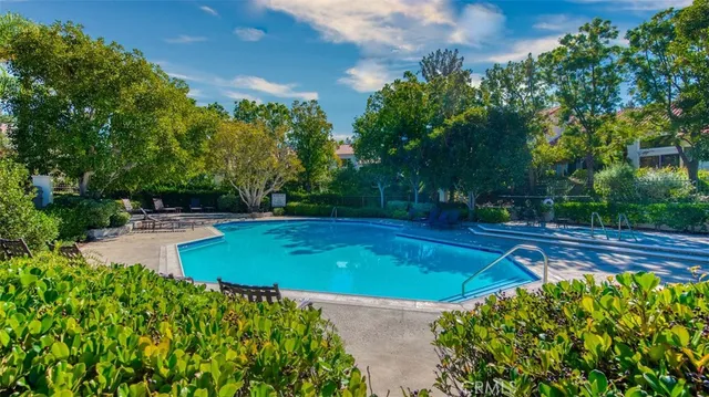 a front view of a house with a yard and fountain