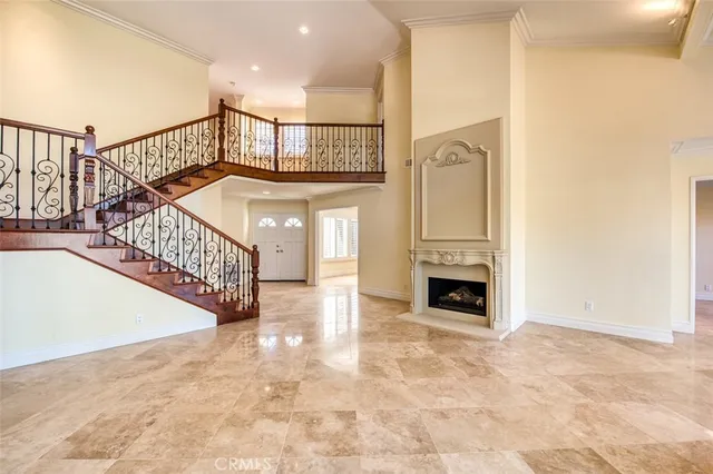 an empty room with windows and fireplace