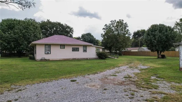 a view of a yard with a house in the background
