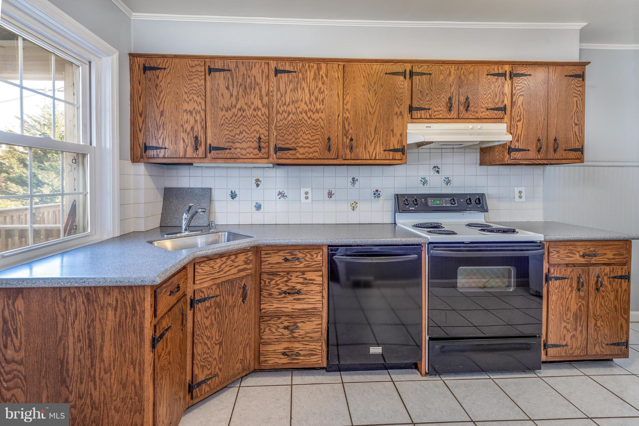 124 Overbrook Road Baltimore, MD 21212 - Photo 6 of 15 Kitchen offering corian counters and ceramic floor