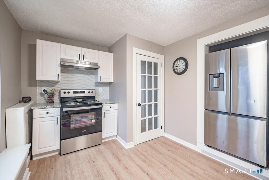 73 Silver Street Middletown, CT 06457 - Photo 14 of 30 a kitchen with stainless steel appliances a stove a refrigerator and a window
