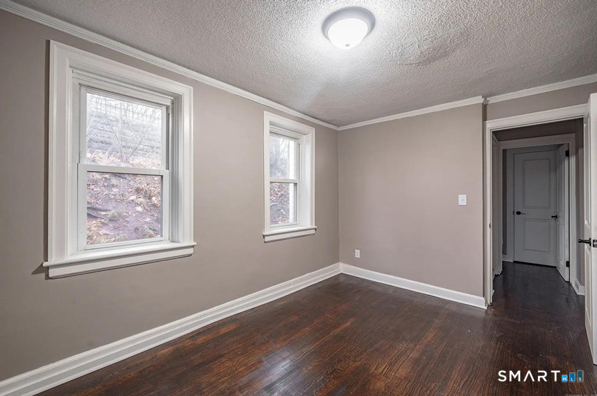 73 Silver Street Middletown, CT 06457 - Photo 15 of 30 a view of an empty room with wooden floor and a window