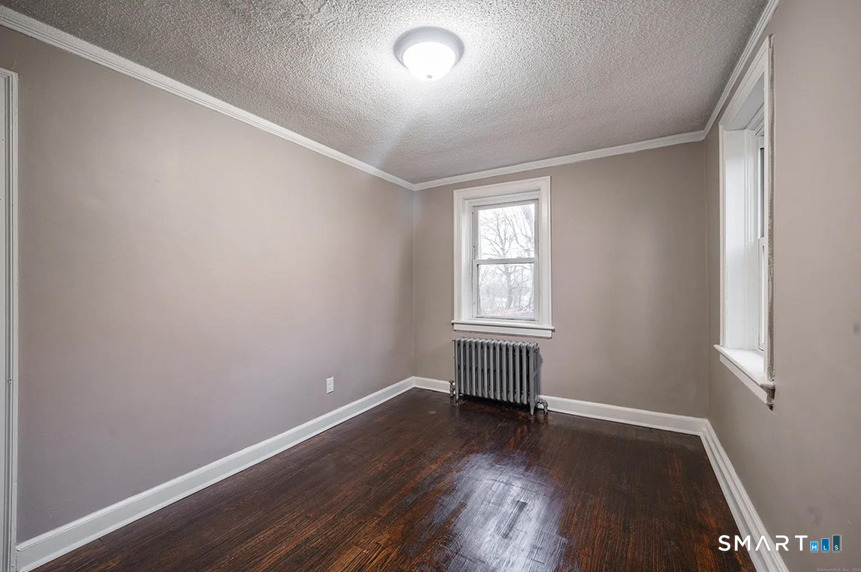 73 Silver Street Middletown, CT 06457 - Photo 17 of 30 an empty room with wooden floor and windows