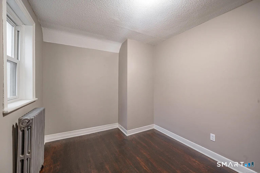 73 Silver Street Middletown, CT 06457 - Photo 19 of 30 a view of an empty room with wooden floor and a window