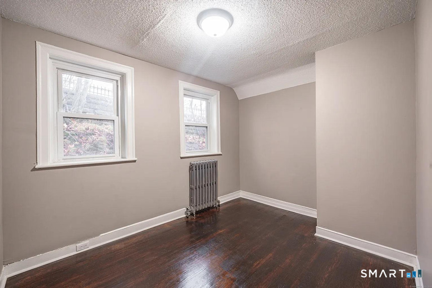 73 Silver Street Middletown, CT 06457 - Photo 20 of 30 a view of an empty room with wooden floor and a window