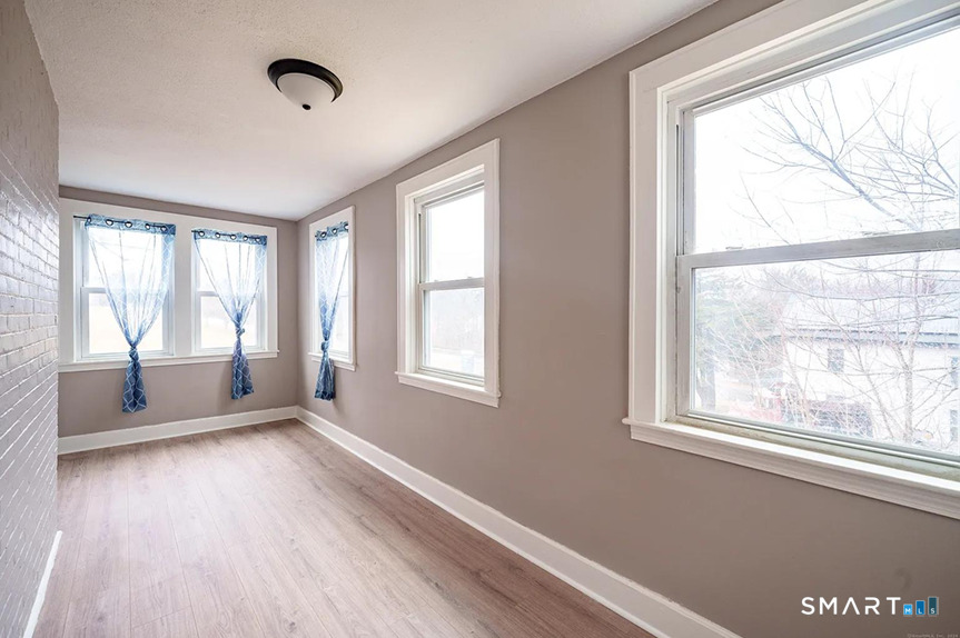 73 Silver Street Middletown, CT 06457 - Photo 9 of 30 a view of an empty room with a window and wooden floor