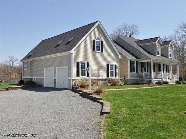 4196 Main Road Tiverton, RI 02878 - Photo 3 of 26 a front view of a house with a garden and trees