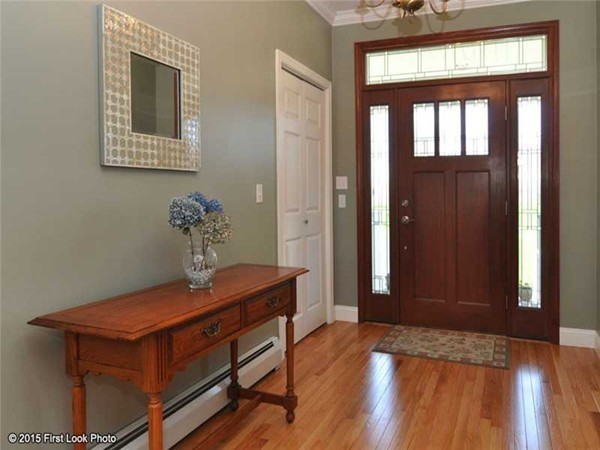 4196 Main Road Tiverton, RI 02878 - Photo 7 of 26 a view of a hallway with wooden floor and a mirror