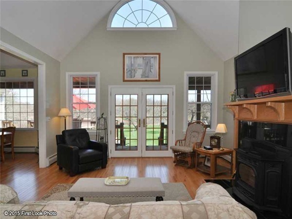 4196 Main Road Tiverton, RI 02878 - Photo 8 of 26 a living room with fireplace furniture and a flat screen tv
