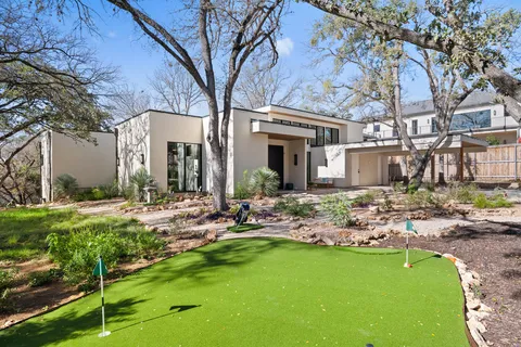 a front view of house with yard and outdoor seating