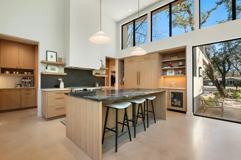 a kitchen that has a lot of cabinets in it and stainless steel appliances