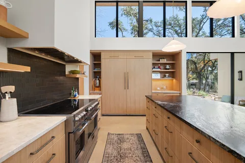 a kitchen with granite countertop a sink and a stove