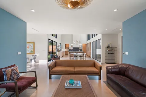 a living room with furniture a ceiling fan and a rug
