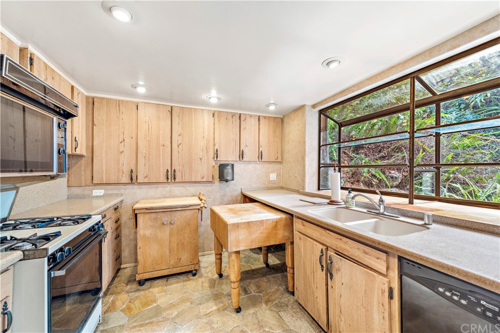 645 Griffith Way Laguna Beach, CA 92651 - Photo 30 of 55 a kitchen with a sink stove and cabinets