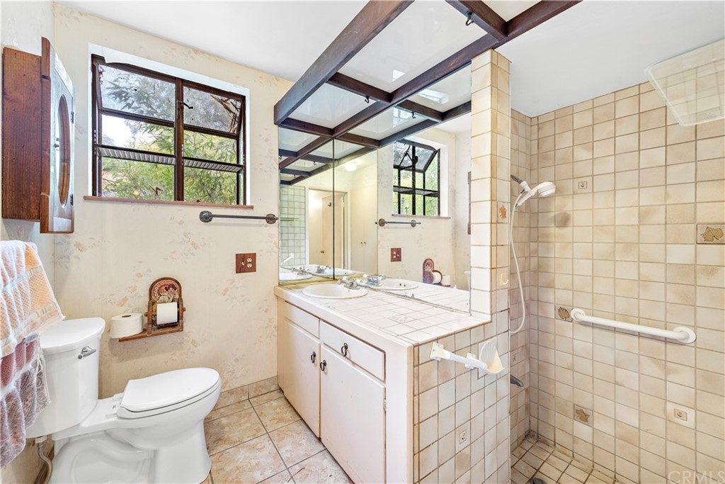 645 Griffith Way Laguna Beach, CA 92651 - Photo 35 of 55 a bathroom with a sink toilet vanity and window