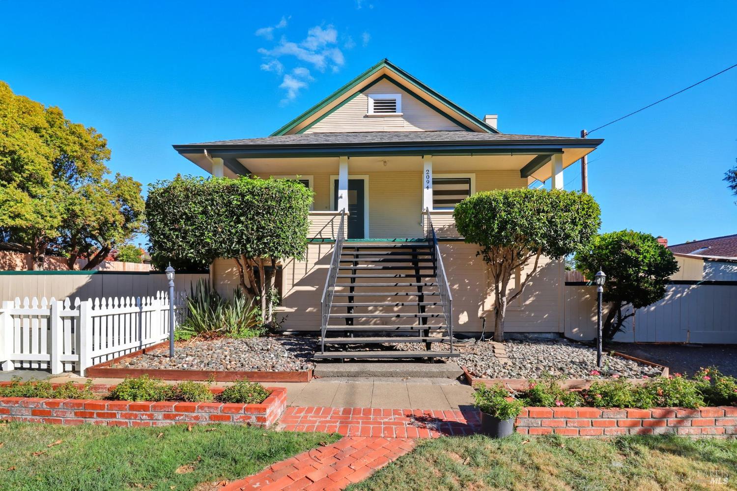 a front view of a house with garden