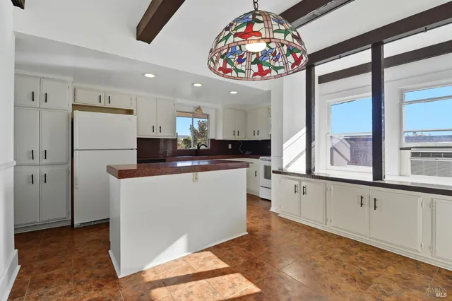 a kitchen with stainless steel appliances granite countertop a refrigerator a sink and a stove