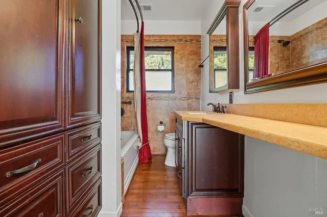 a hallway with a large window and furniture