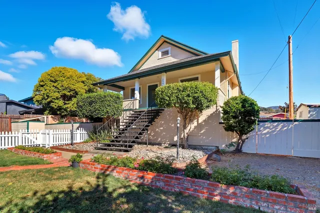 a front view of a house with garden
