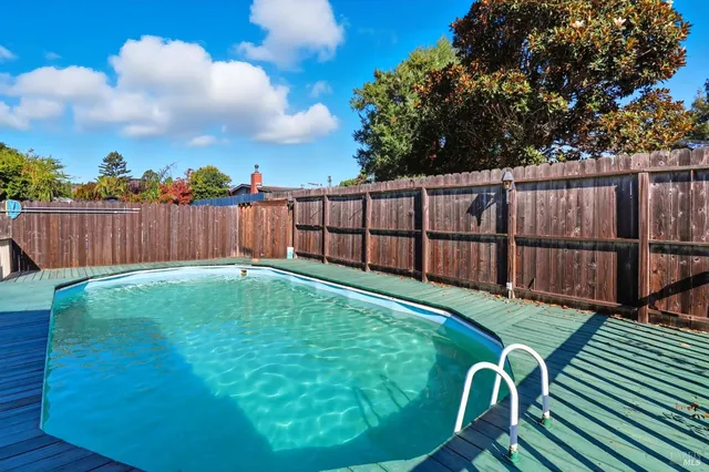 a view of a backyard with wooden fence