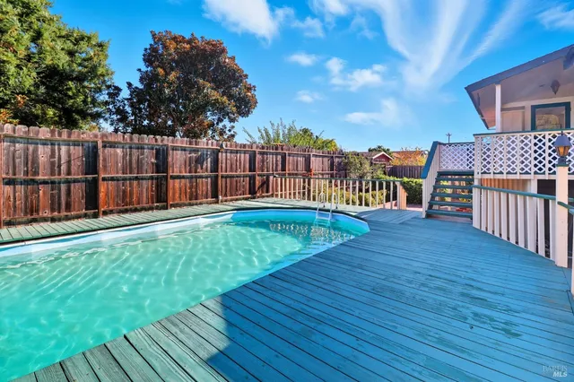 a balcony with table and chairs