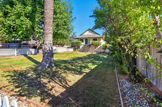 a view of a house with swimming pool and sitting area