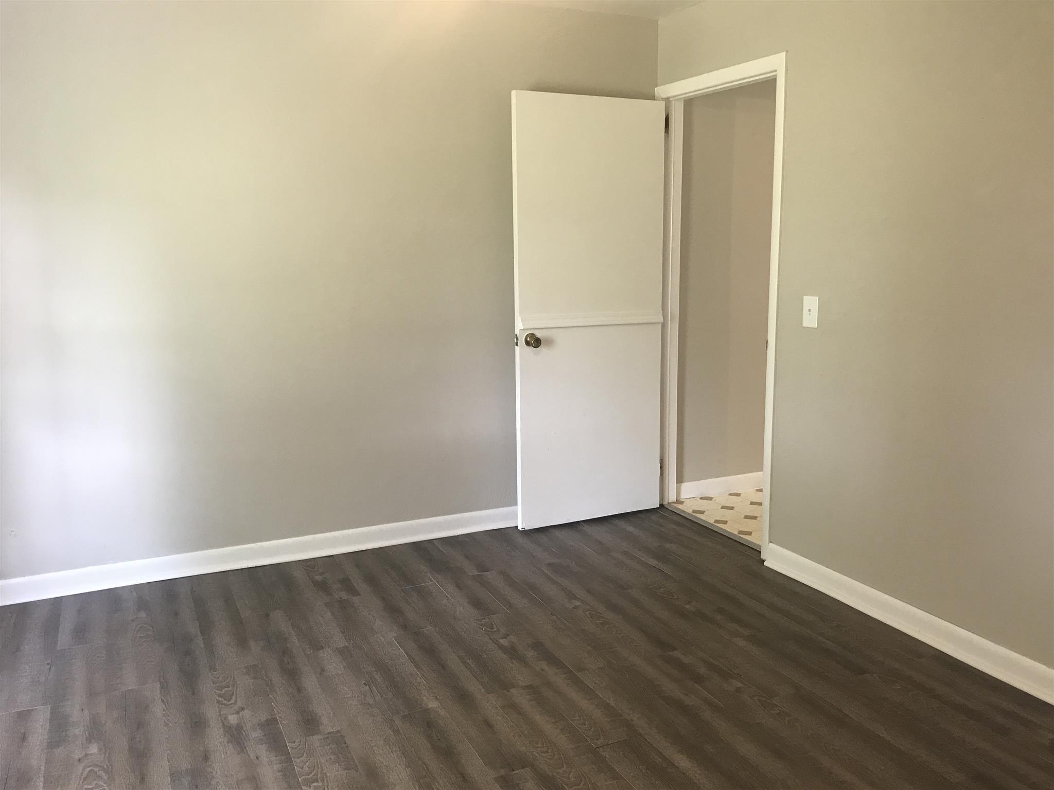5925 Fulton Road Springfield, TN 37172 - Photo 11 of 18 a view of an empty room with wooden floor and a window