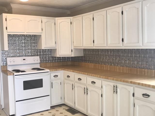 5925 Fulton Road Springfield, TN 37172 - Photo 12 of 18 a kitchen with white cabinets and white appliances