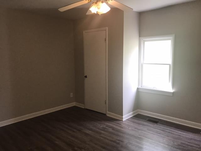 5925 Fulton Road Springfield, TN 37172 - Photo 10 of 18 an empty room with wooden floor and windows