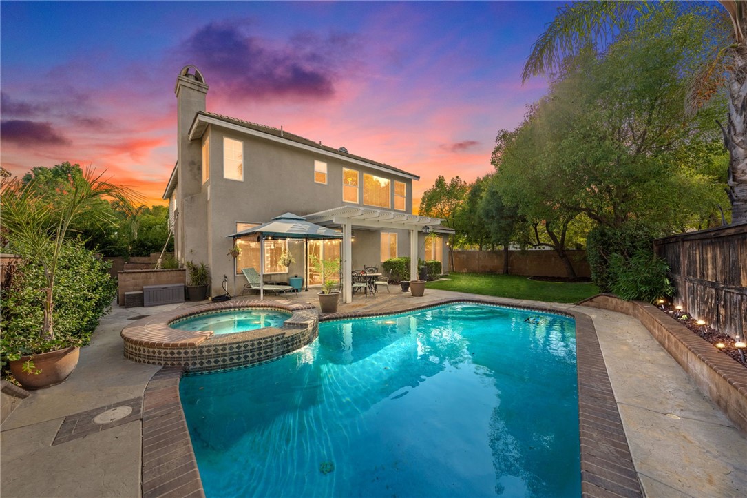 a view of a house with swimming pool and a yard