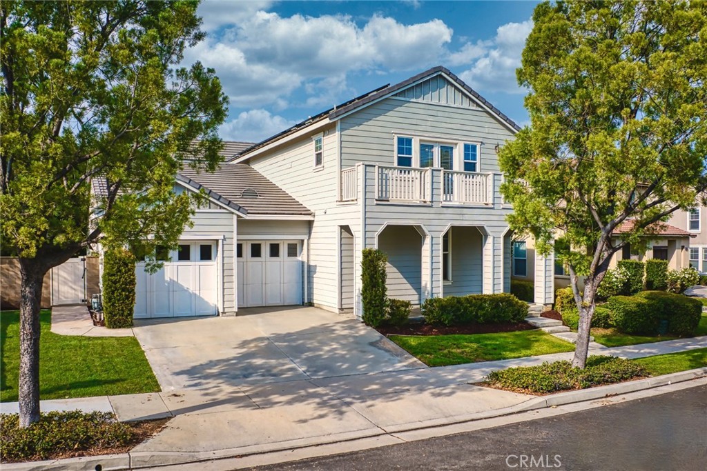 29248 Easton Place Temecula, CA 92591 - Photo 2 of 47 a front view of a house with a yard and garage
