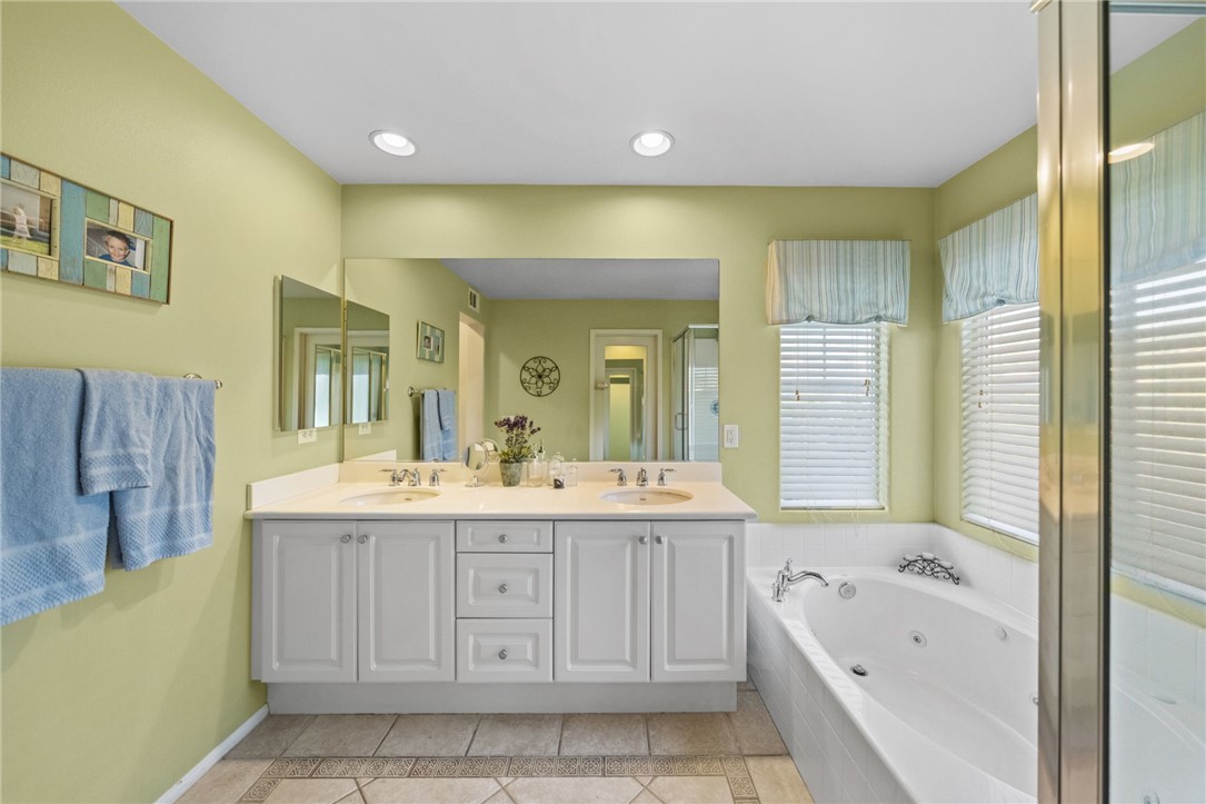 29248 Easton Place Temecula, CA 92591 - Photo 24 of 47 a bathroom with a tub a sink double vanity and a mirror