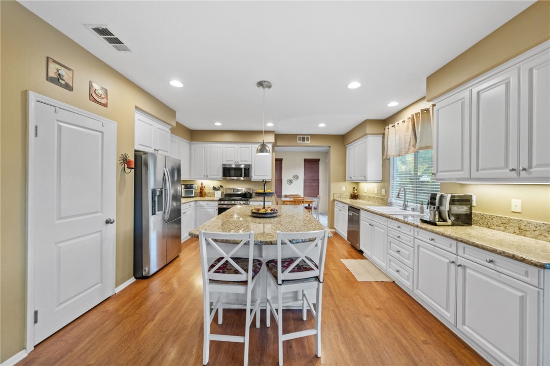 29248 Easton Place Temecula, CA 92591 - Photo 7 of 47 a large kitchen with a table and chairs