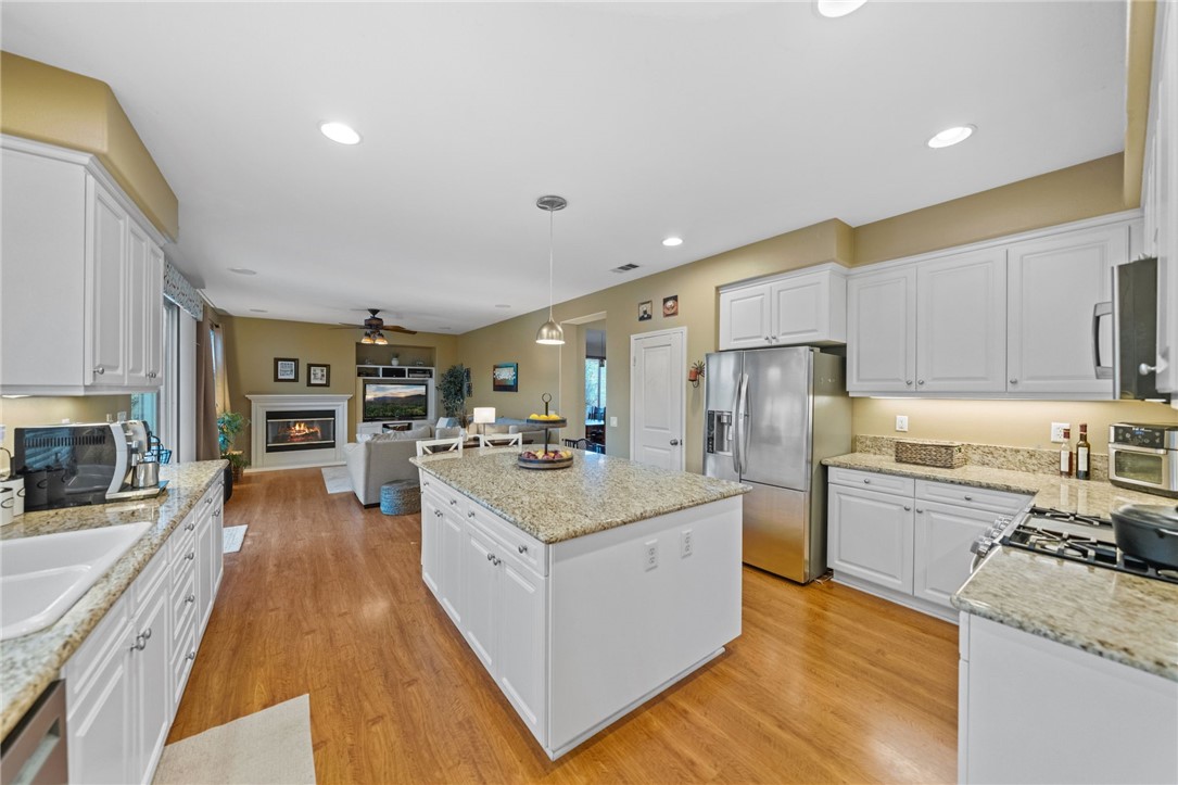 29248 Easton Place Temecula, CA 92591 - Photo 10 of 47 a large kitchen with stainless steel appliances kitchen island granite countertop a large center island and a stove