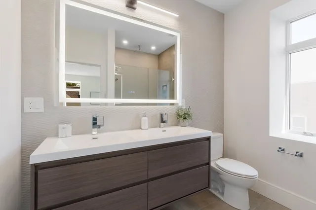 a bathroom with a sink toilet and mirror