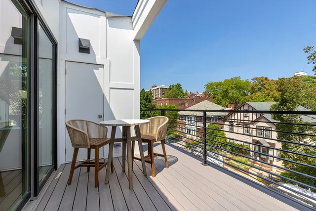 a view of a balcony with chairs