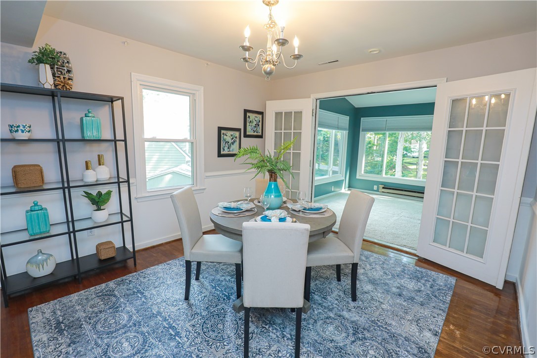 12935 Ashtree Road Midlothian, VA 23114 - Photo 11 of 50 a dining room with furniture a rug and a chandelier