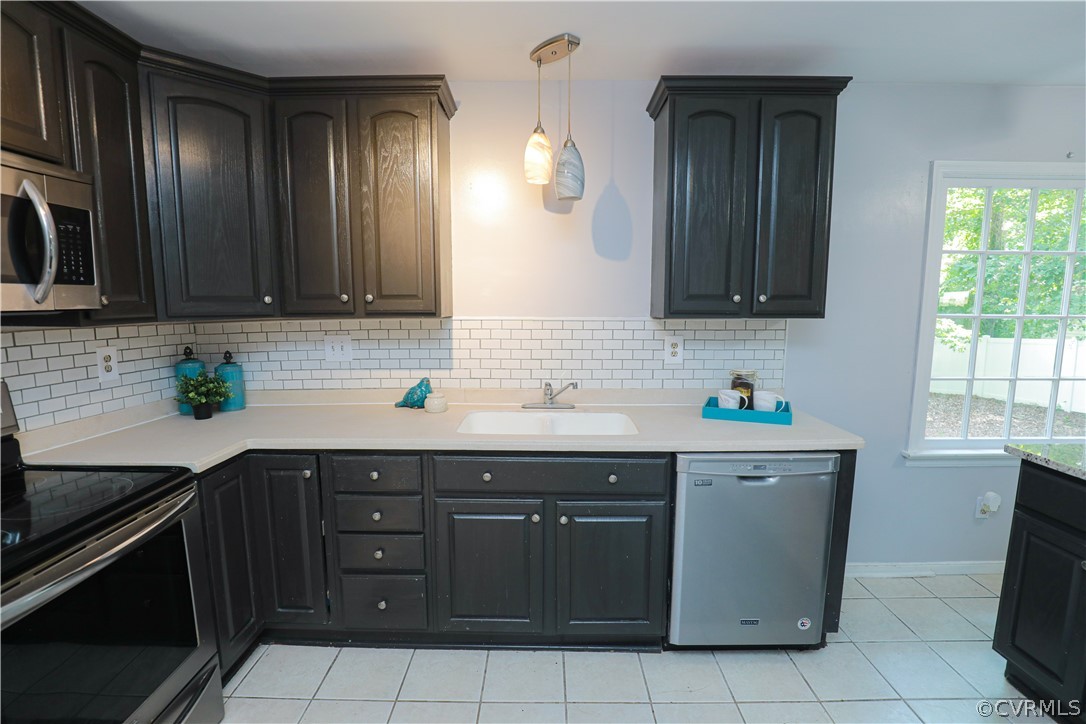 12935 Ashtree Road Midlothian, VA 23114 - Photo 14 of 50 a kitchen with stainless steel appliances granite countertop a sink stove and cabinets