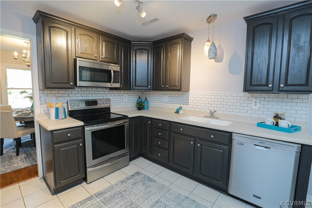 12935 Ashtree Road Midlothian, VA 23114 - Photo 15 of 50 a kitchen with a sink stove and microwave