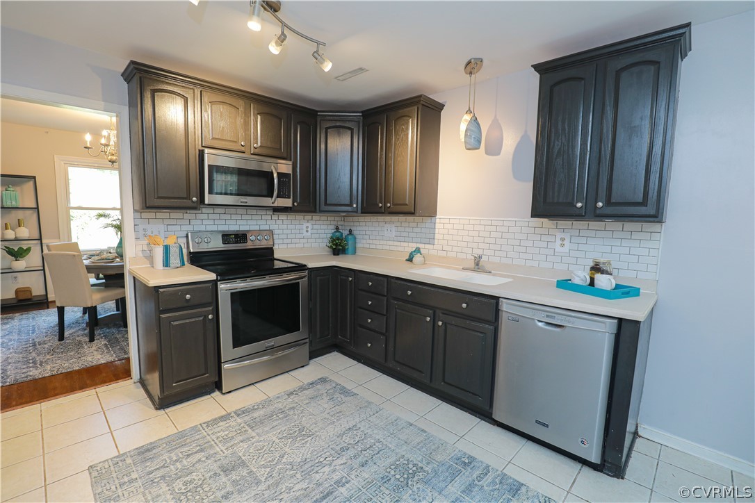 12935 Ashtree Road Midlothian, VA 23114 - Photo 16 of 50 a kitchen with stainless steel appliances granite countertop wooden cabinets a stove top oven a sink and dishwasher