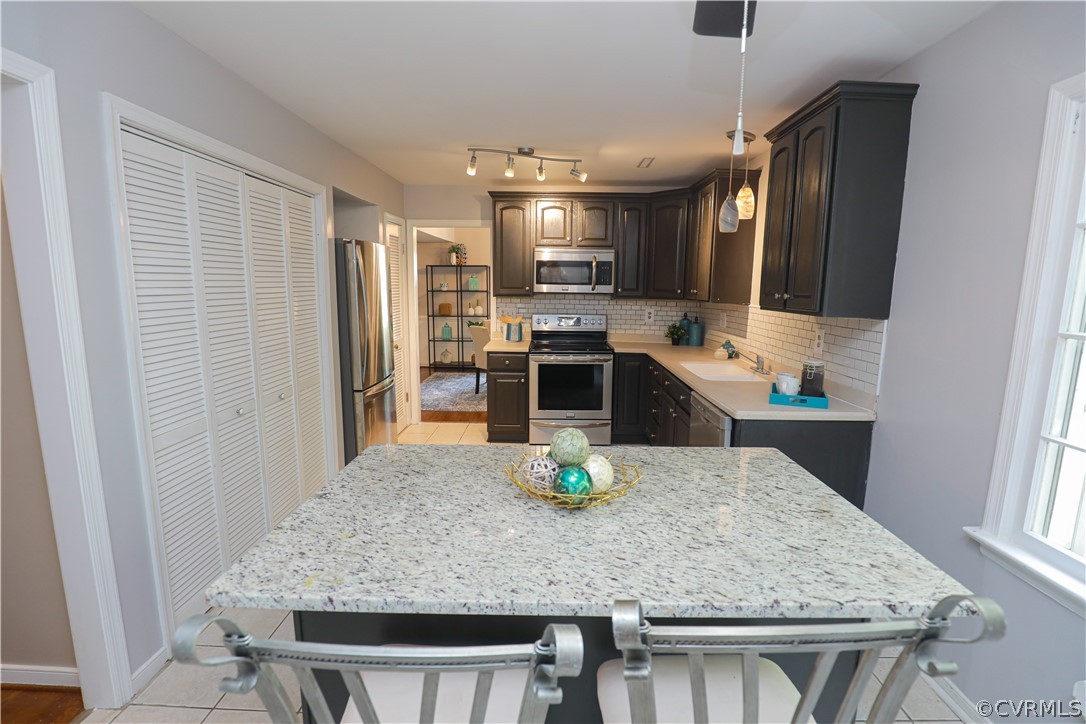 12935 Ashtree Road Midlothian, VA 23114 - Photo 19 of 50 a kitchen with kitchen island stainless steel appliances a sink stove and refrigerator