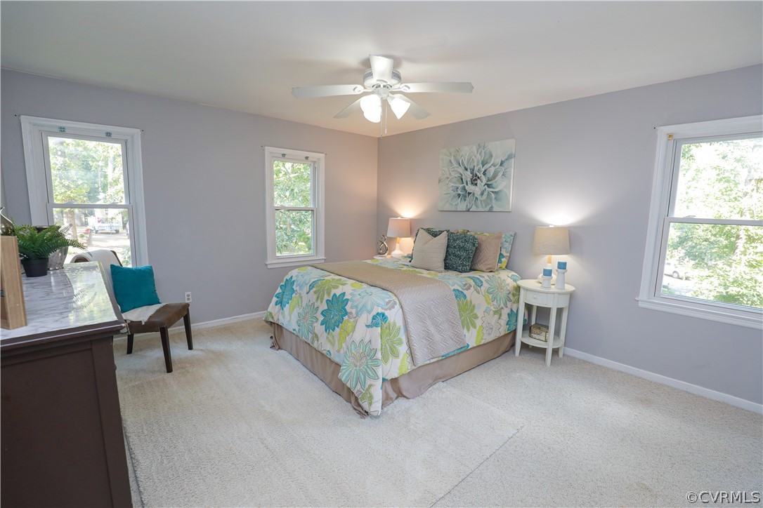 12935 Ashtree Road Midlothian, VA 23114 - Photo 28 of 50 a bedroom with a bed and a chandelier