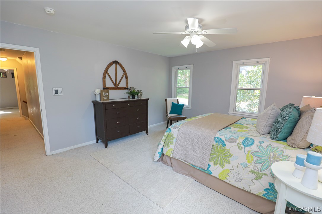 12935 Ashtree Road Midlothian, VA 23114 - Photo 29 of 50 a bedroom with a bed and a chandelier