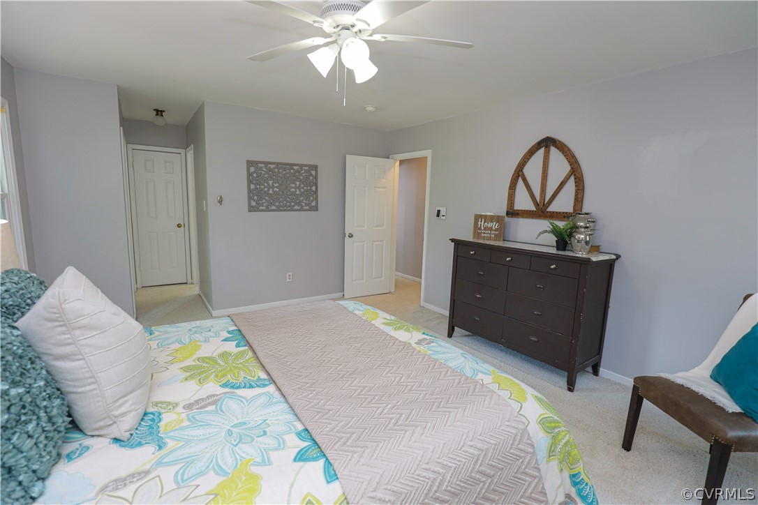 12935 Ashtree Road Midlothian, VA 23114 - Photo 30 of 50 a bedroom with a bed and a chandelier