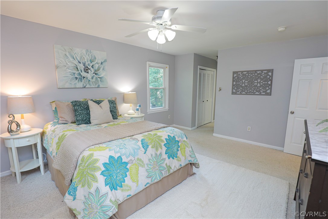 12935 Ashtree Road Midlothian, VA 23114 - Photo 31 of 50 a bedroom with a bed and a chandelier