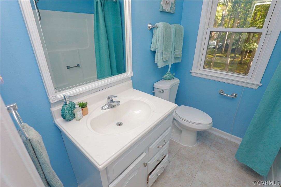 12935 Ashtree Road Midlothian, VA 23114 - Photo 40 of 50 a bathroom with a sink a toilet and shower