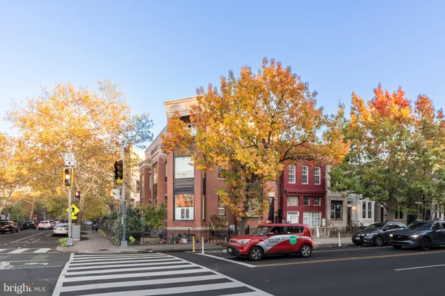 a city street lined with buildings and trees