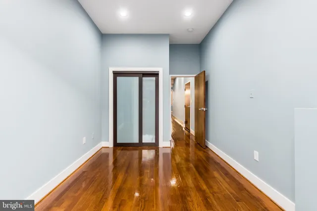 a view of hallway with wooden floor