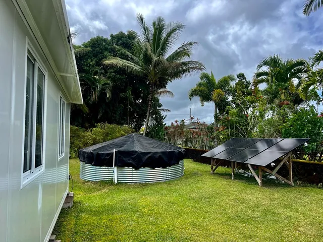 a backyard of a house with table and chairs