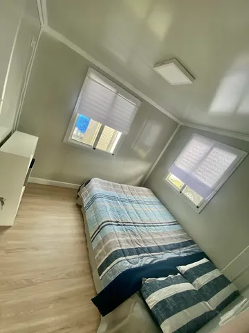 a bedroom with a bed and balcony